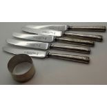 Five hallmarked silver butter knives and a hallmarked silver napkin ring