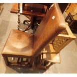 Upholstered leather chair a wicker stool and a small dropleaf occassional table