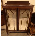 Glazed mahogany display cabinet with ball and claw feet