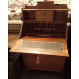 Edwardian bureau with dropfront and leather insert concealing two drawers and twelve pigeon holes