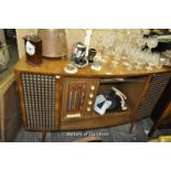 1950's Décor radiogram, sliding doors and shaped front,with Bakelite record player, 125 x 47 x 87cm