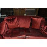 Low back wide armed red velour upholstered two-seater sofa, on short turned and square form