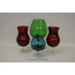 Four oversized coloured galsses including brandy and hurricane glass