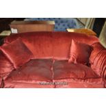 Low back wide armed red velour upholstered two-seater sofa, on short turned and square form