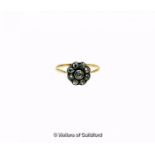 Diamond daisy cluster ring, nine old cut diamonds rubover set in white metal, on a yellow shank,