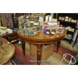 Late Victorian walnut circular extending dining table with two leaves, wind-out mechanism, four