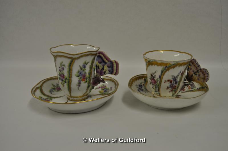 Two continental cups and saucers; floral and gilt decoration, unusual butterfly handles