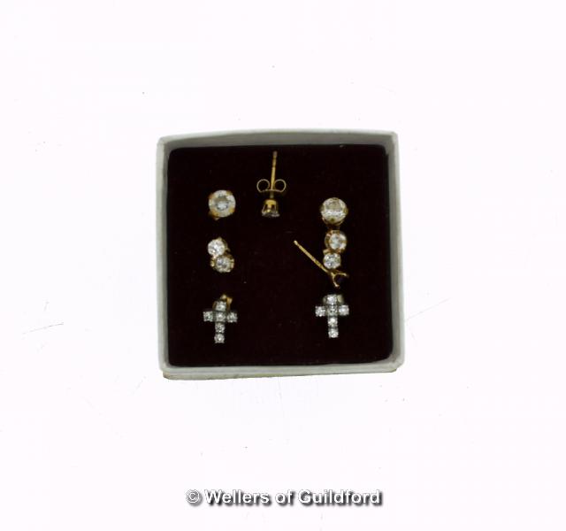 *Four pairs of yellow metal ear studs, stamped as 9ct, set with white cubic zirconia stones,