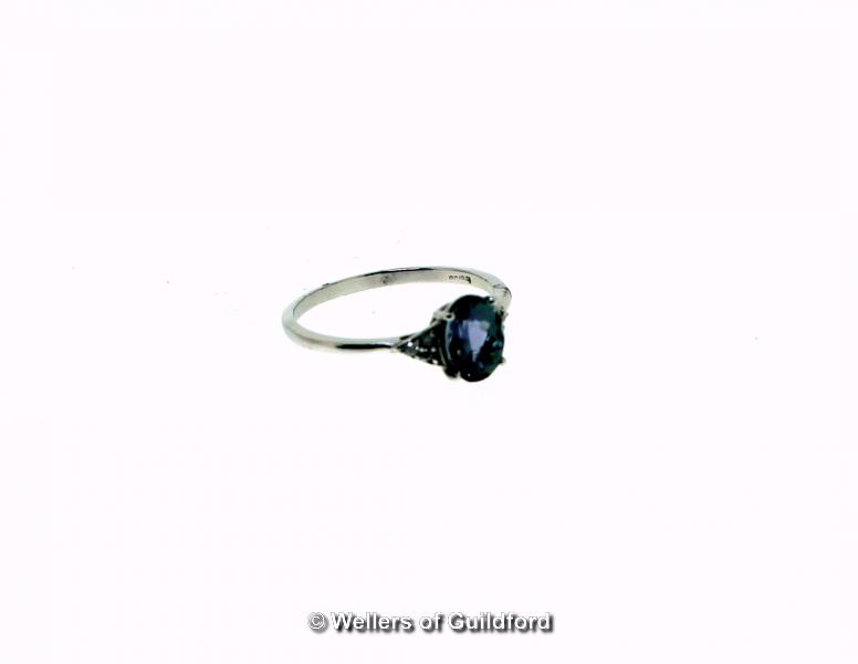 Tanzanite and diamond ring, oval cut tanzanite, weighing an estimated 1.42cts, with three small