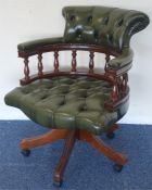 A leather mounted swivel office chair on turned su