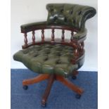 A leather mounted swivel office chair on turned su