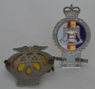 A Royal Scots car badge together with an AA badge.