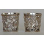 A pair of Japanese small vase holders decorated wi