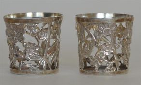 A pair of Japanese small vase holders decorated wi