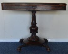 A rosewood swivel top card table on pedestal base.