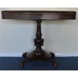 A rosewood swivel top card table on pedestal base.