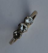A diamond mounted three stone ring in 18 carat and