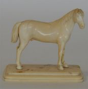 An unusual carved ivory figure of a horse on pedes