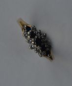 A small diamond sapphire and diamond cluster ring