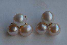 A pair of diamond and pearl cluster earrings in go