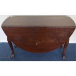 A heavy mahogany oval drop leaf table. Est. £60 -