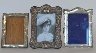 A group of three picture frames decorated with flo