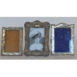 A group of three picture frames decorated with flo