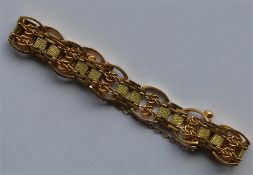 A heavy gold bracelet with concealed clasp and saf