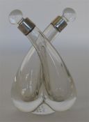 A small conjoined oil and vinegar bottle with stop