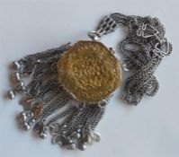 A heavy Continental necklace with ring supports an