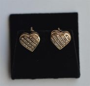 A pair of 18 carat heart shaped earrings inset wit