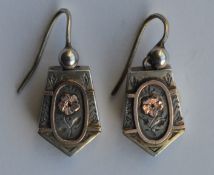 An attractive pair of silver earrings decorated wi