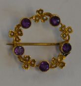 A circular amethyst and pearl brooch in gold. Appr