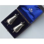 A boxed pair of silver peppers with reeded decorat