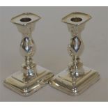 A good pair of shaped candlesticks on rectangular