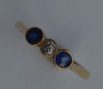 A small sapphire and diamond three stone ring in 1