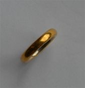 A 22 carat gold plain wedding band. Approx. 9.8 gr