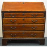 A Georgian mahogany bureau on bracket feet with fi