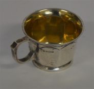 A heavy panelled christening cup with gilded inter