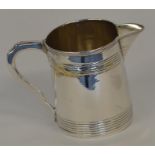 A Georgian tapering cream jug with reeded body and