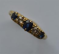 A sapphire and diamond five stone half hoop ring i