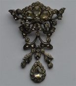 A large silver and paste brooch with matching drop