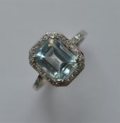 A good blue stone and diamond rectangular cluster