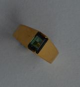 A 14 carat gold and tourmaline single stone ring.