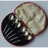 A boxed set of six coffee spoons with reeded termi