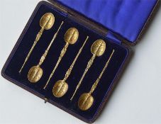 A boxed set of six silver gilt spoons with engrave