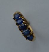 A sapphire five stone half hoop ring in 18 carat c