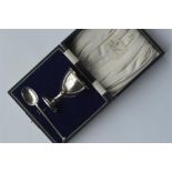 A boxed egg cup and spoon with reeded sides. Est.