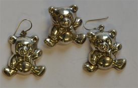 A pair of novelty silver earrings in the form of t