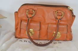 A brown leather Marc Jacobs handbag with white dus